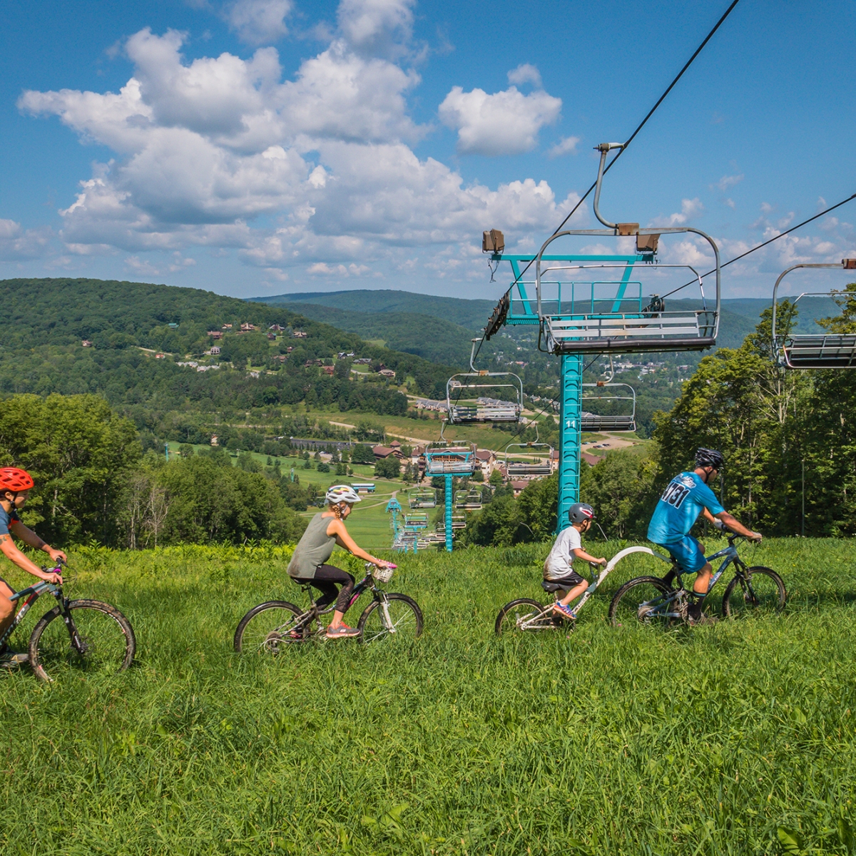 Mountain Biking family overlooking Holiday Valley Resort's base area (2021)