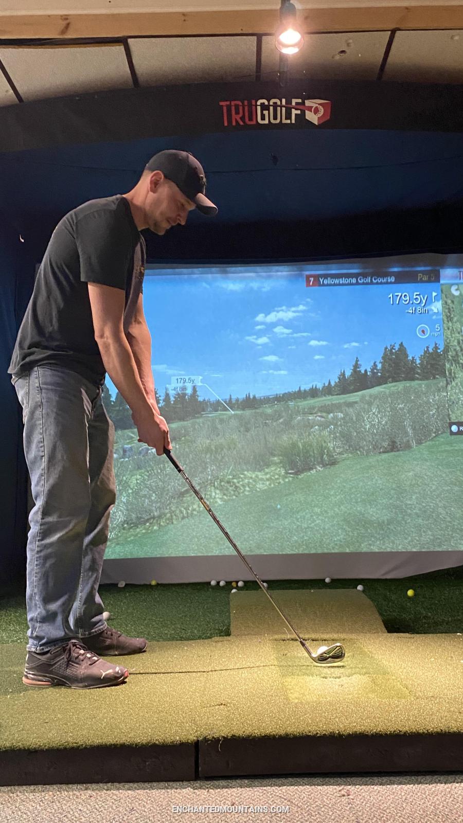 Golfer using the simulator