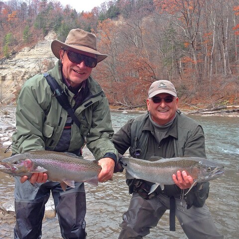 Two men holding fish caught in Catt creek