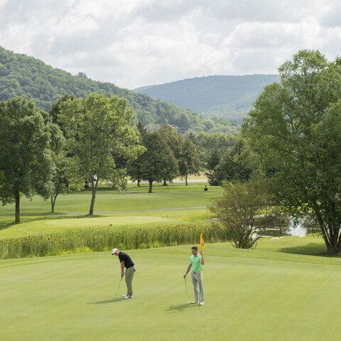 Guys golfing on Double Black Diamond golf course at Holiday Valley