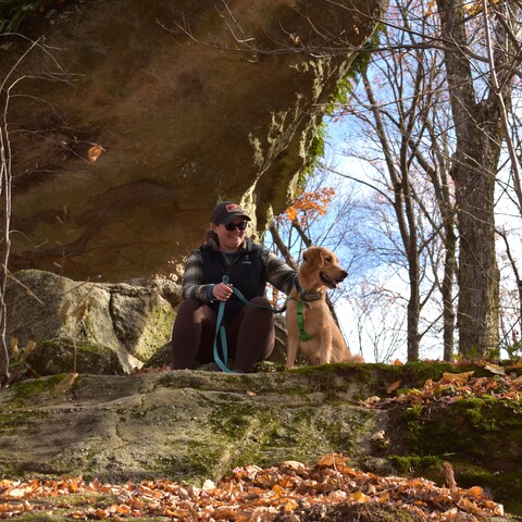 A hiker and their dog taking a break at Rock City Park