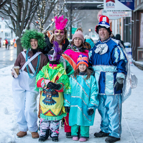 Family posing during Mardi Gras in Ellicottville