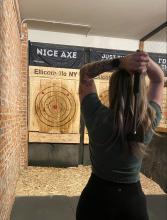 Woman throwing an axe at Ratchet Hatchet